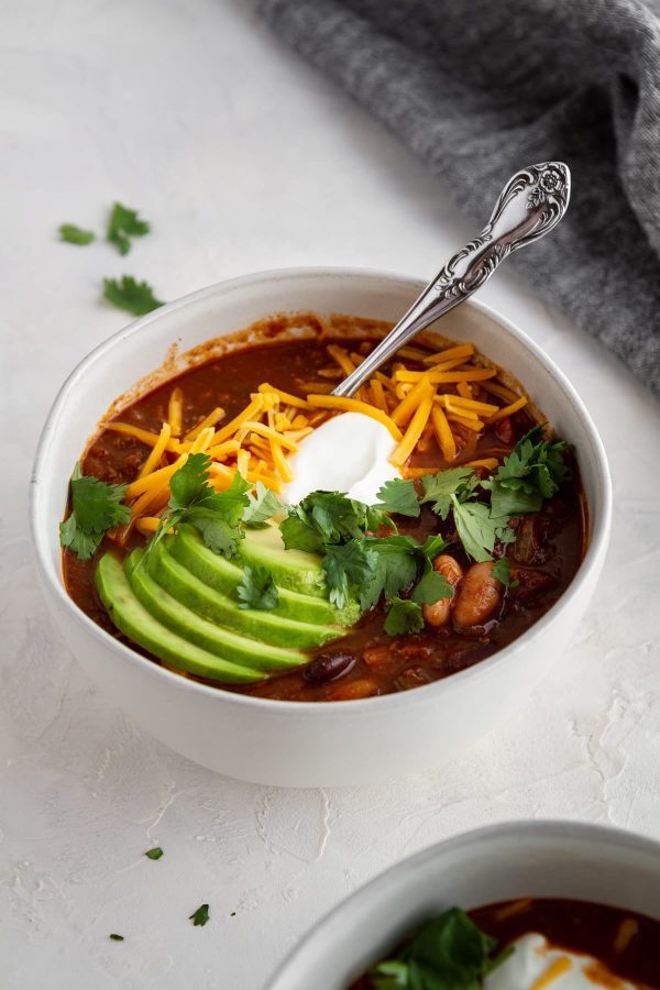 beef and red wine chili in a bowl with toppings