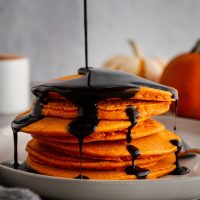 halloween pancakes on a plate with syrup poured on top