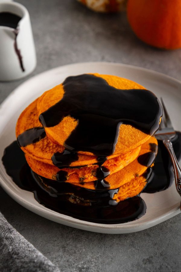stack of halloween pancakes on a plate with syrup on top