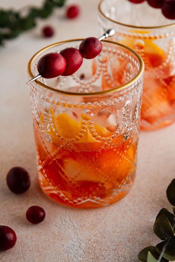 glass of cranberry old fashioned on a surface