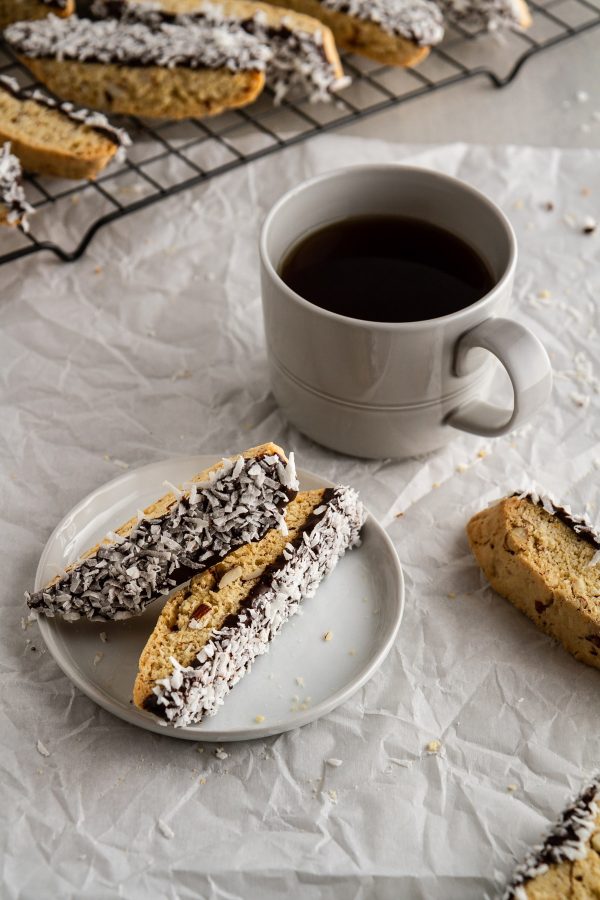 almond joy biscotti on a plate with coffee