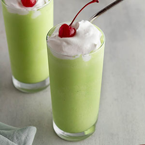 shamrock shakes in glasses on a surface.