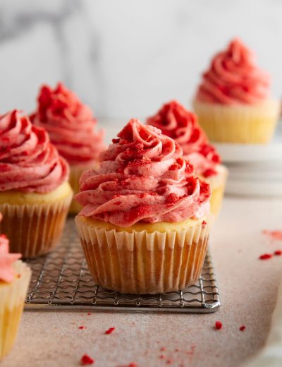 strawberry shortcake cupcakes on a cooling rack