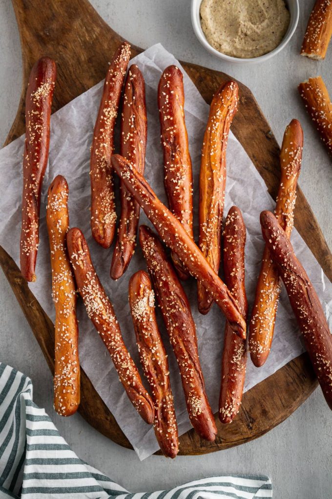 homemade hard pretzel rods stacked on a cutting board