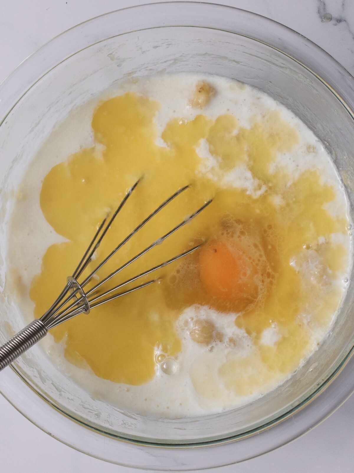 Milk and eggs in bowl.