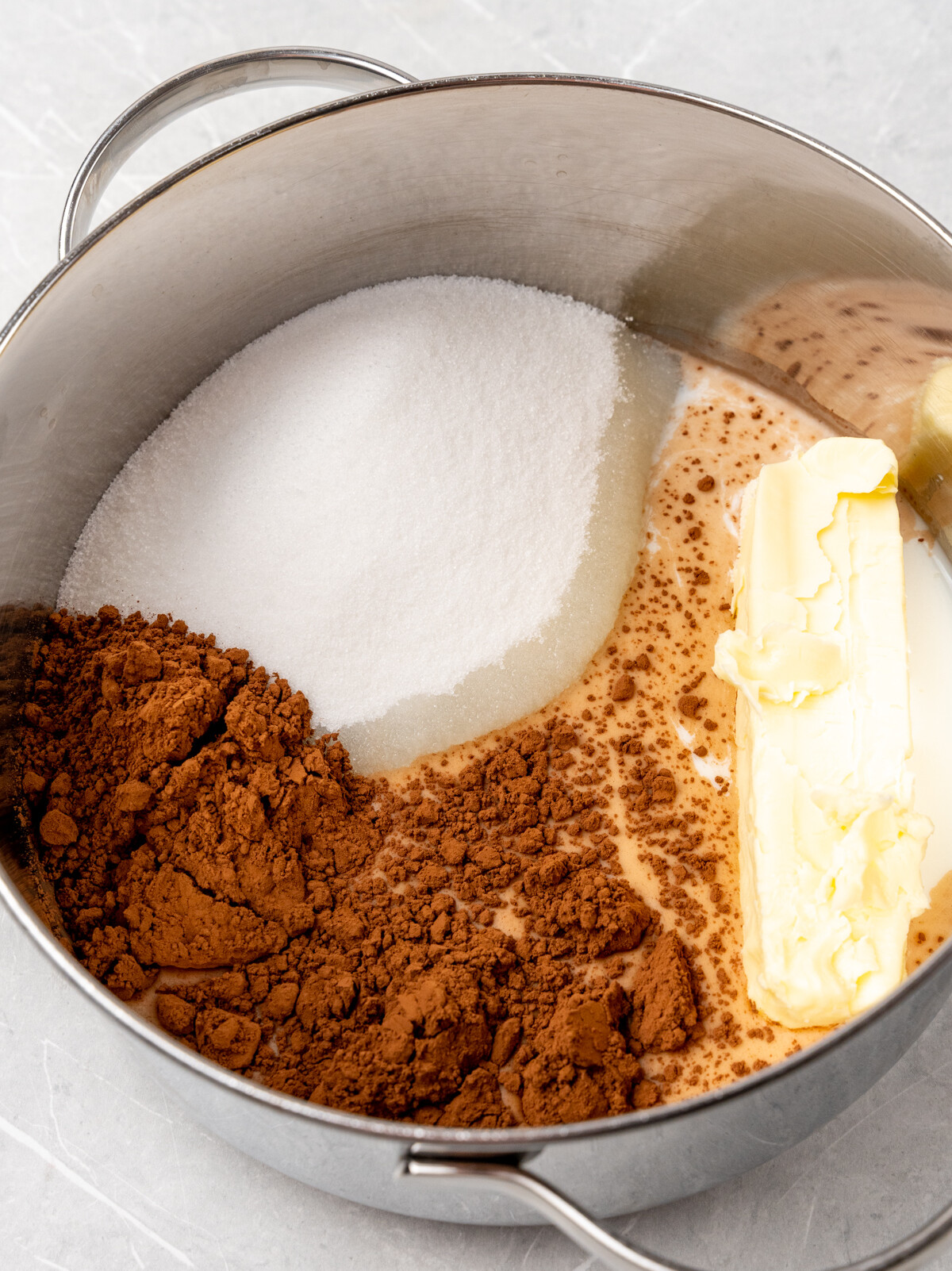 Cocoa, sugar and butter in pan.
