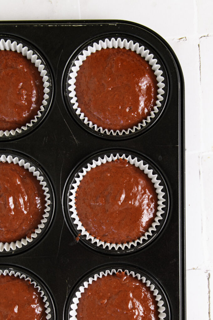 Cupcake pan with red dough.
