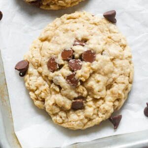 chewy oatmeal chocolate chip cookie on parchment.