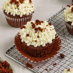 red velvet cupcake with cream cheese frosting piped unwrapped.