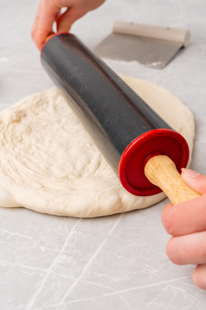 Rolling pin with pizza dough.