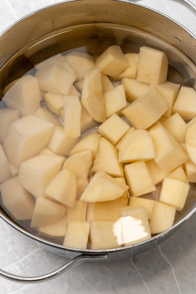 Cubed potatoes in saucepan.