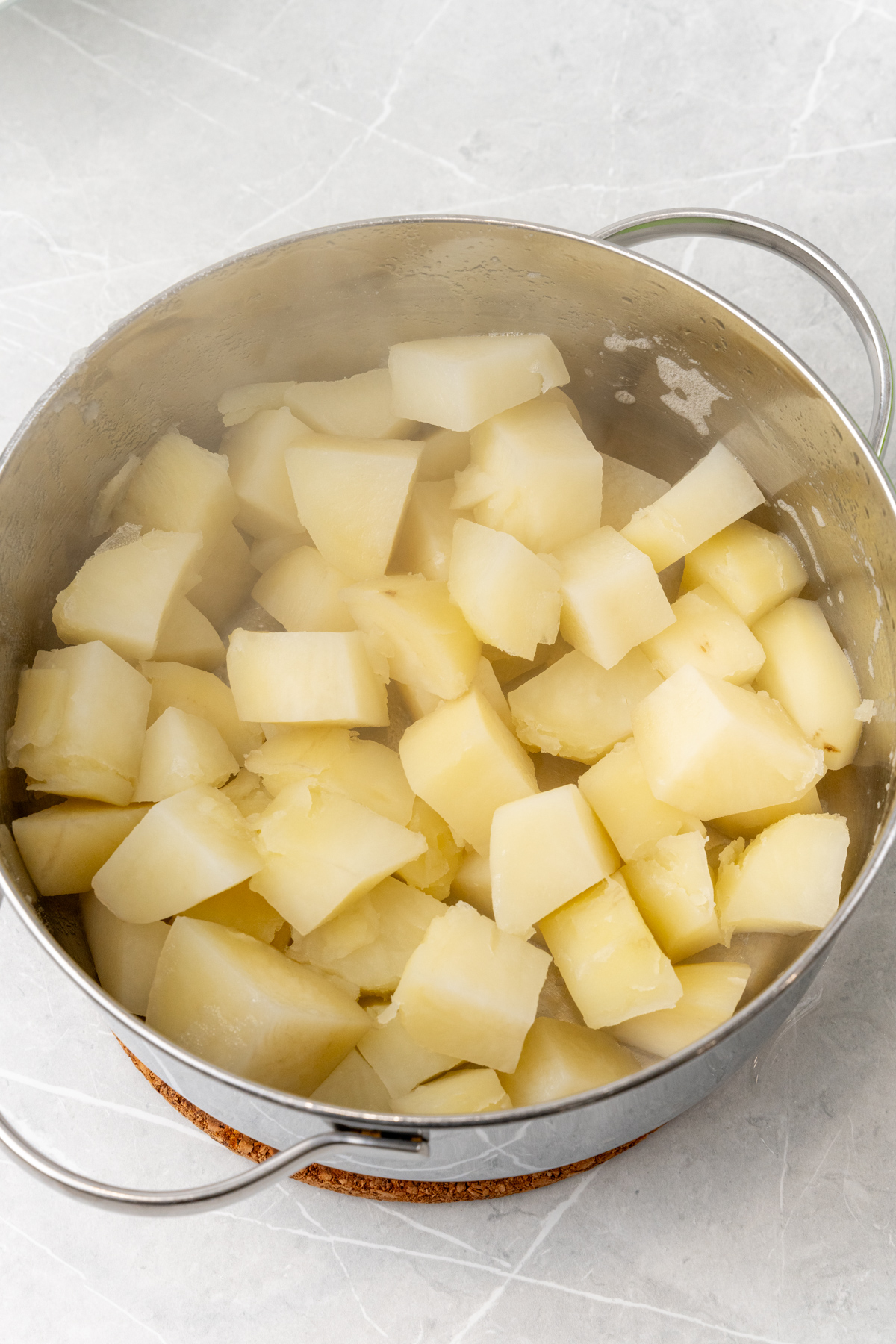 Potato cubes in pan.