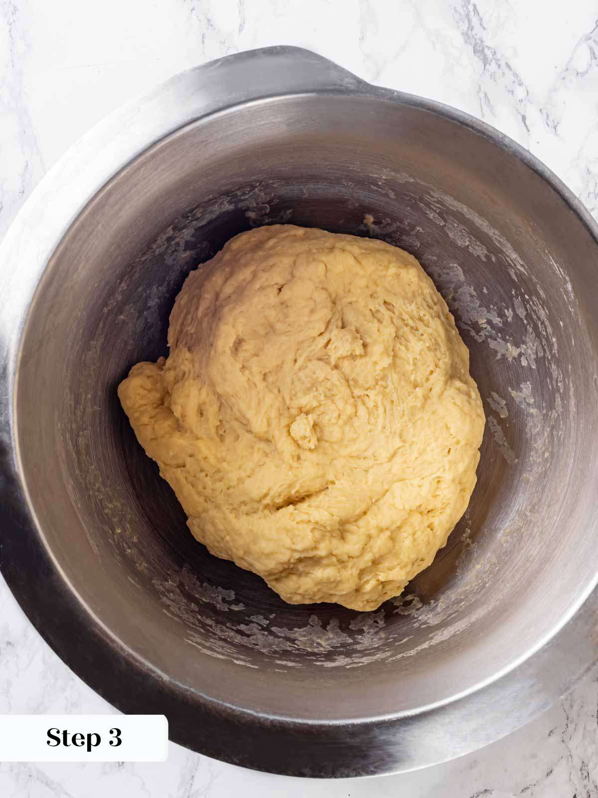 mixed brioche dough in mixer bowl.