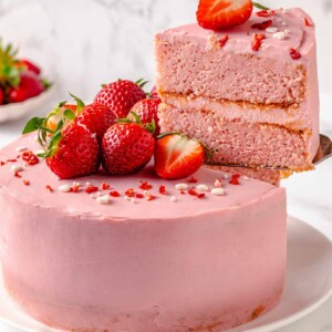removing slice of strawberry cake on server.