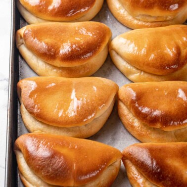 traditional folded pocketbook shape of parker house rolls baked and buttered.