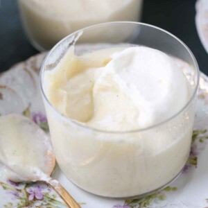 A spoon dipping into vanilla pudding.