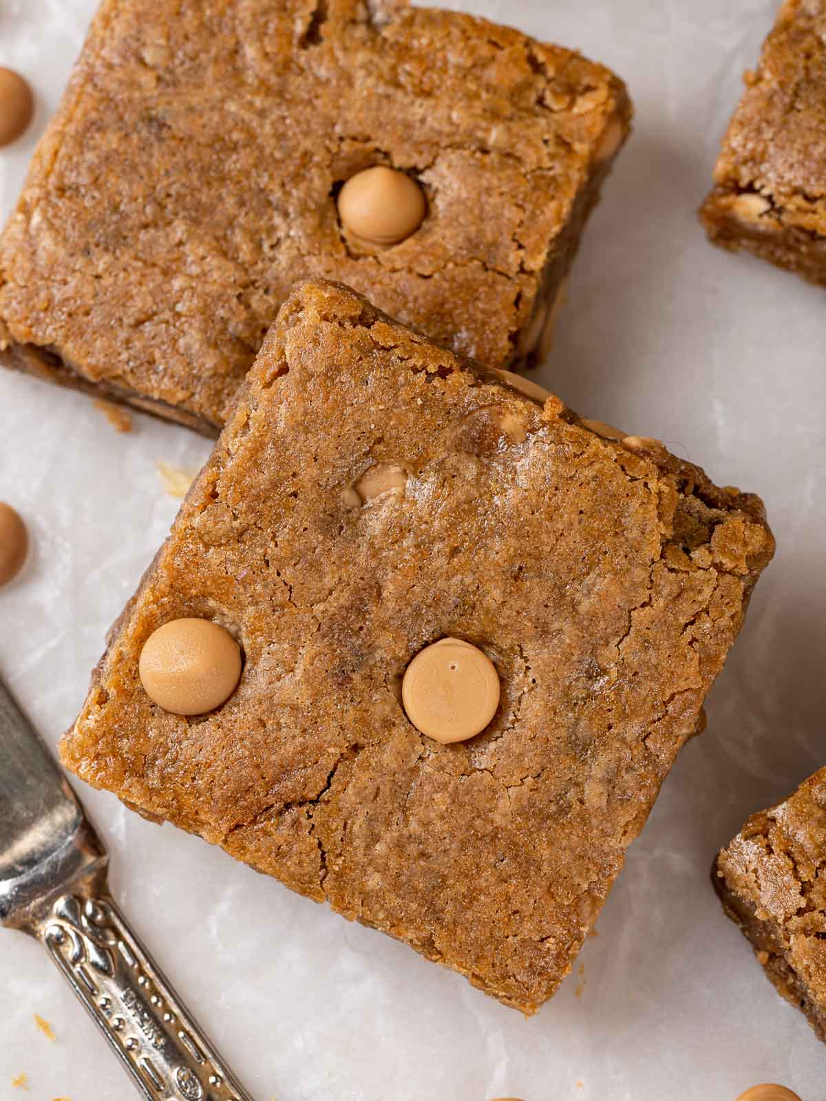 two blondies sliced and arranged on parchment.