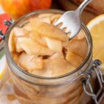 Open jar of apple pie filling.