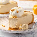 A slice of pumpkin no-bake cheesecake with a silver fork on the side.