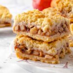 Two stacked apple pie bars.