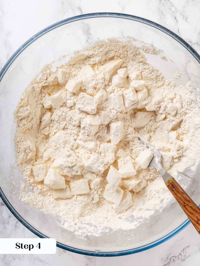 tossing butter and shortening in flour mixture for dough.