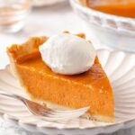 A clean, perfectly sliced piece of sweet potato pie.