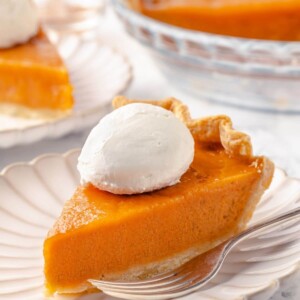 Sweet potato pie served on a plate with scalloped edges.