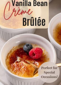Close-up of homemade crème brûlée with a crackly sugar topping, garnished with fresh berries for an elegant presentation.