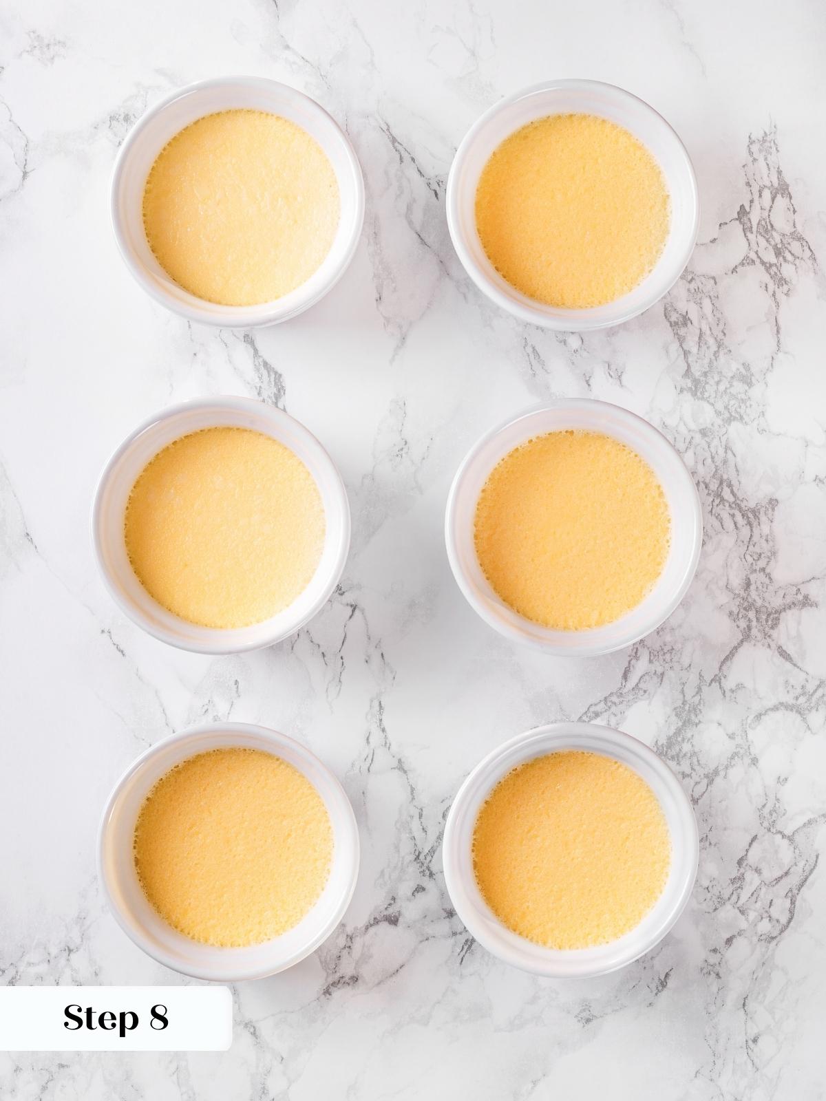 Creme brulee custards freshly baked and cooling in ramekins.