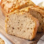 A sliced loaf of beer bread showing its soft interior.