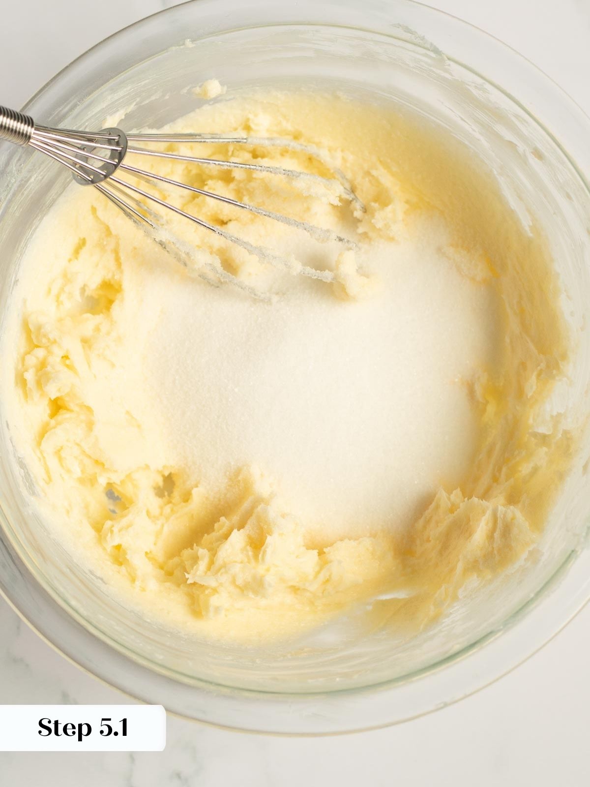 Step-by-step shot of milk being added to the cake mixture.