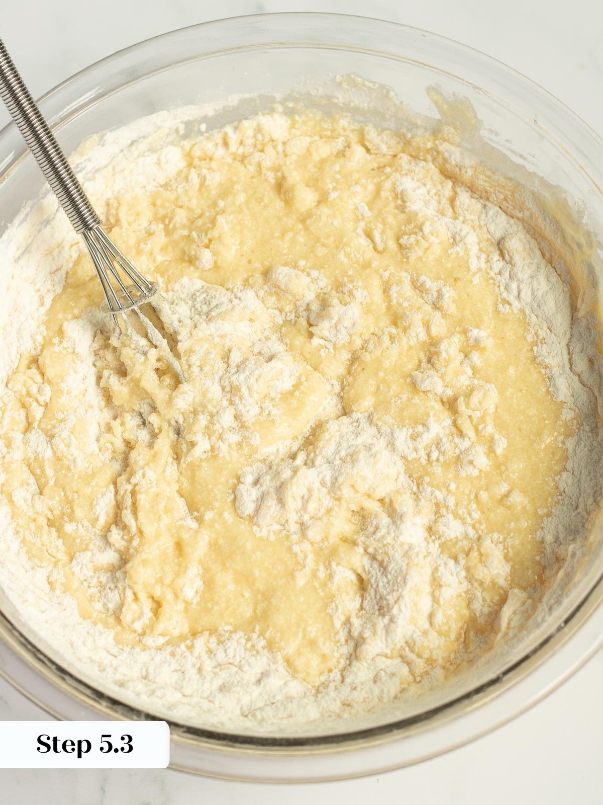 cake batter being stirred in a mixing bowl.