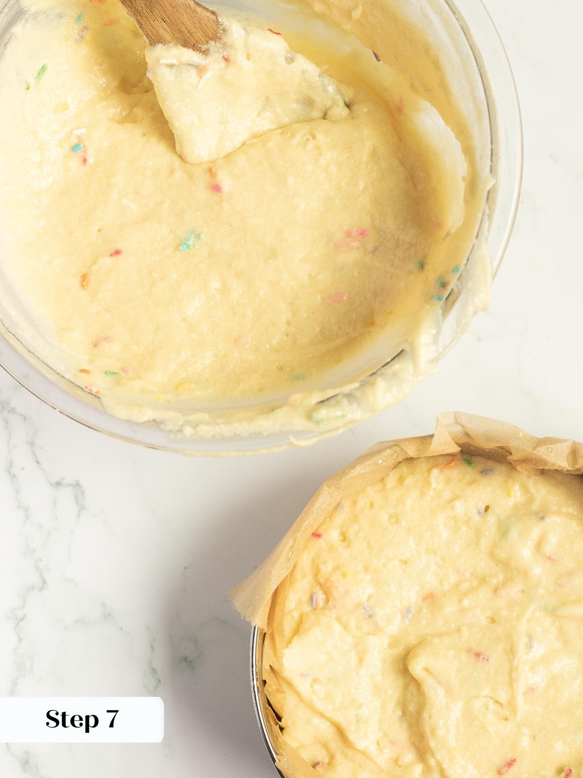Dividing the funfetti cake batter evenly between cake pans.