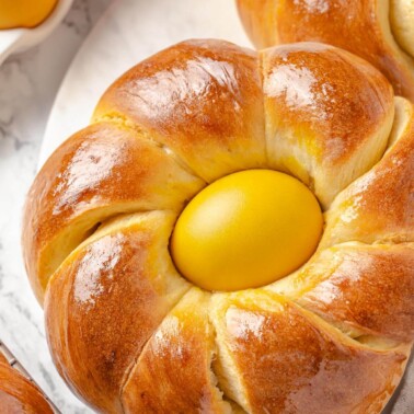 Soft bread twisted into a crown to cradle an egg.