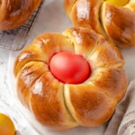 Freshly baked Italian bread with shiny tops and braided texture.