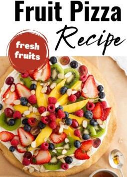 Soft sugar cookie crust topped with white frosting, fresh fruit, and drizzled honey.