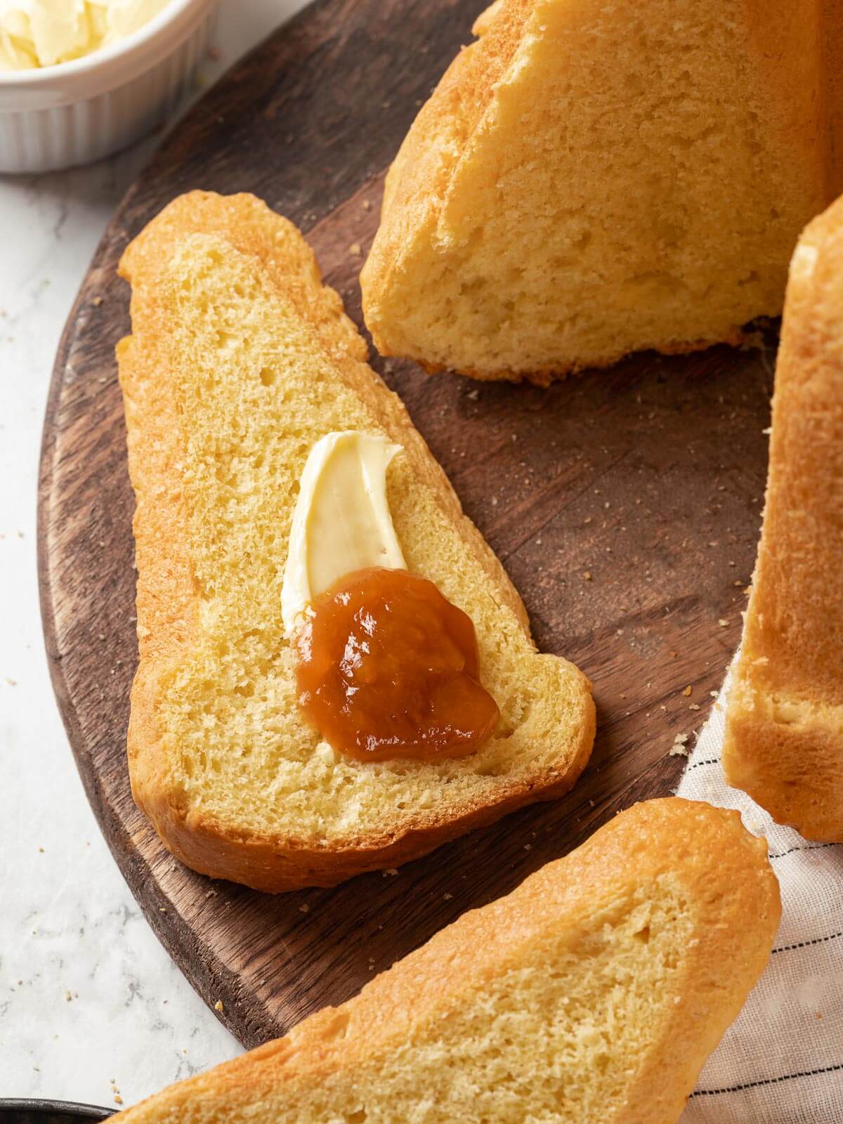 Slice of Sally Lunn bread with melted butter on top.
