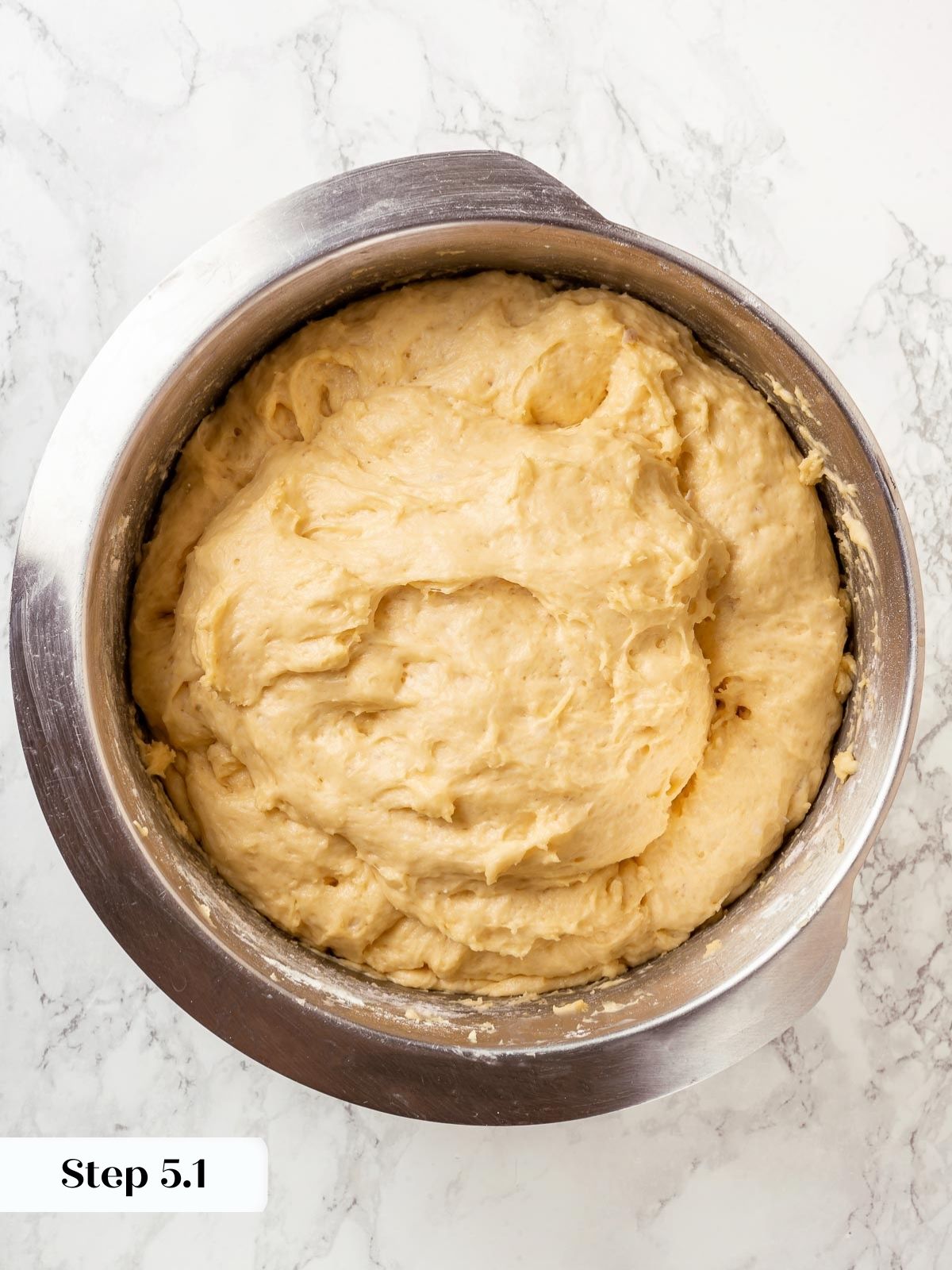 Proofed Sally Lunn bread with puffy texture.