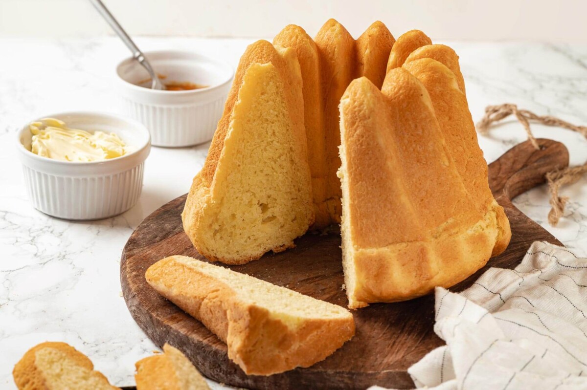 Bread displayed for serving on a wooden cutting surface.