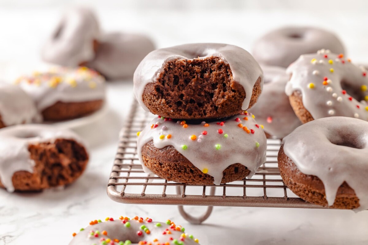 The inside of a donut reveals a soft, fluffy cake-like texture full of chocolate flavor.