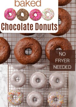 A wire rack full of chocolate donuts with glaze and sprinkles cooling after baking in the oven.