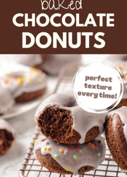 Homemade baked chocolate donuts with a shiny glaze sitting on cooling rack, ready to serve kids.