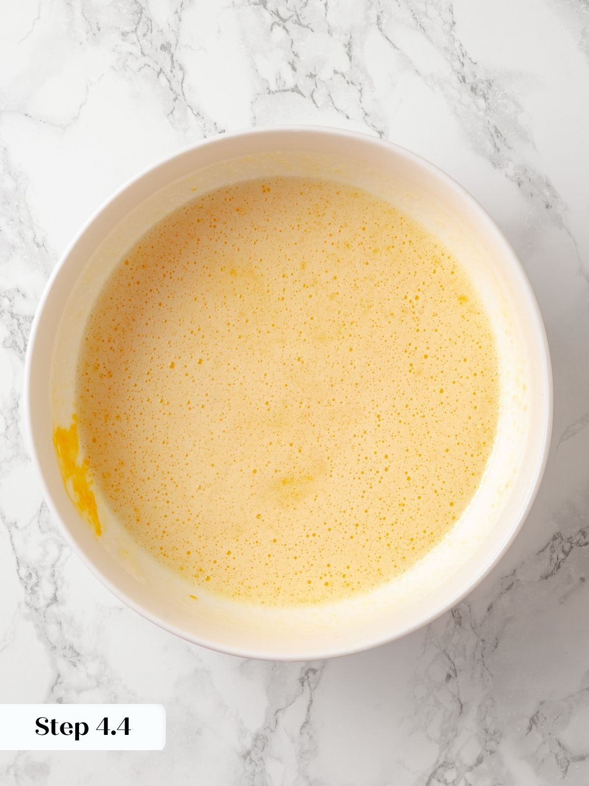 All wet ingredients are now fully combined into a smooth mixture for moist baked donuts.