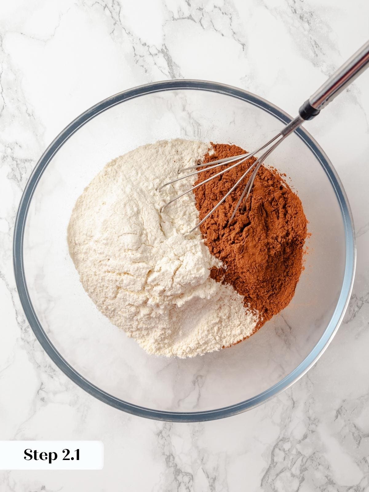 Dry ingredients like flour and cocoa being whisked together for even baking.