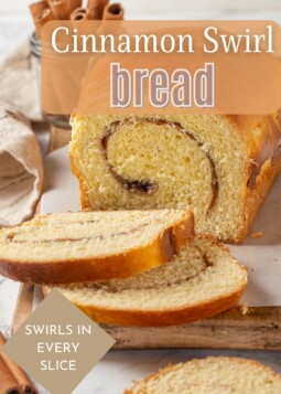 A sliced loaf of cinnamon swirl bread with visible sugary layers and soft, golden-brown crust.