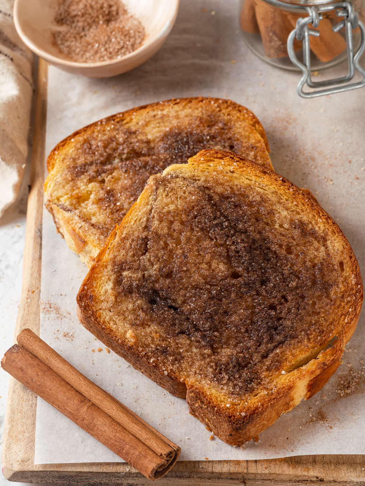 Toasted bread slices with a golden cinnamon sugar crust and lightly browned buttery surface.