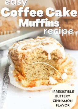 Muffin with lines of white glaze and a bite taken out.