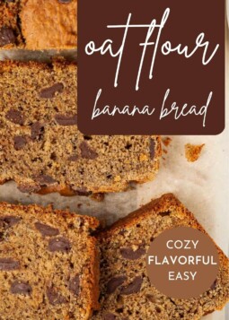 Thick banana bread slice on paper with tender crumb and bits of melted chocolate visible.