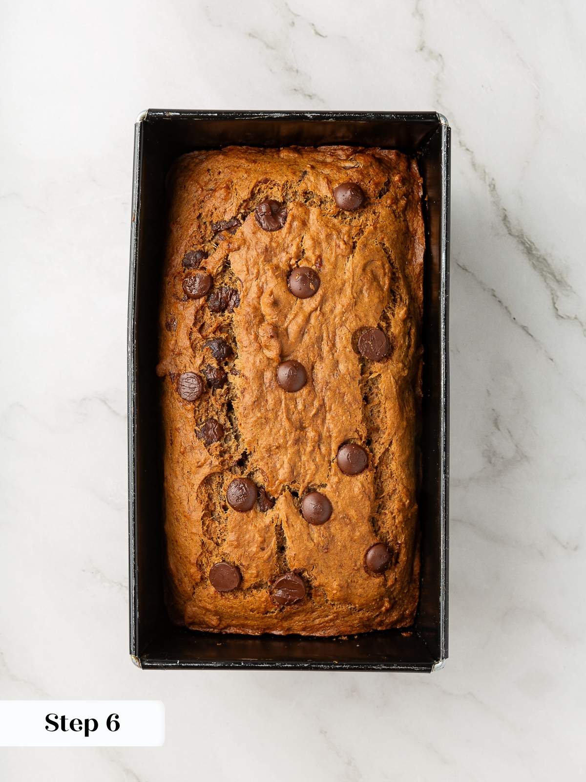 Fully baked banana bread still in pan, resting before being turned out to cool.