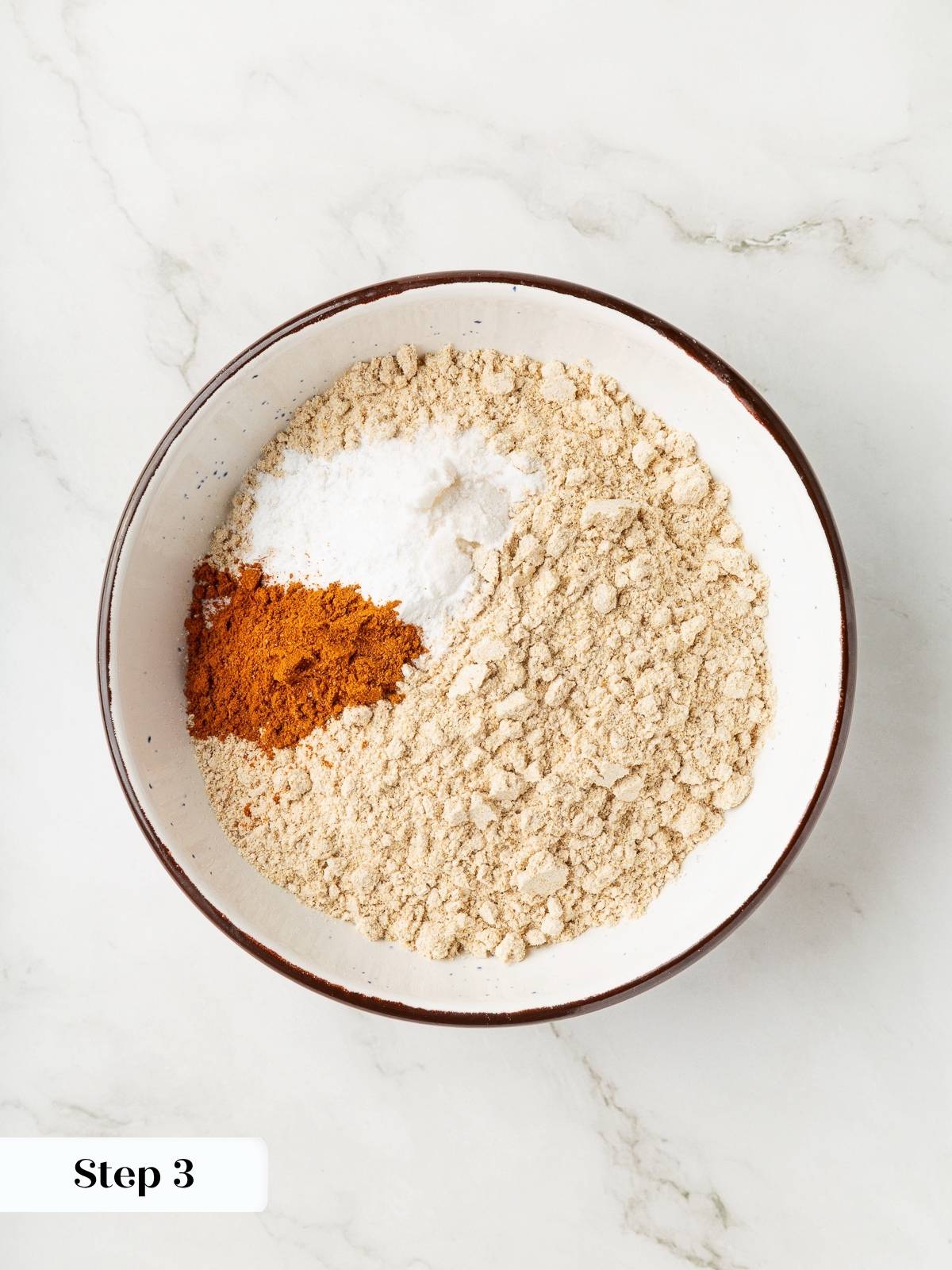 Dry ingredients being blended evenly before combining with wet banana mixture.